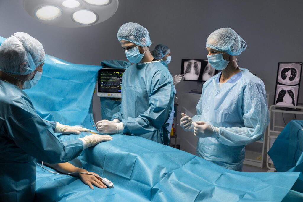 Surgeons performing an operation in a hospital operating room under bright surgical lights